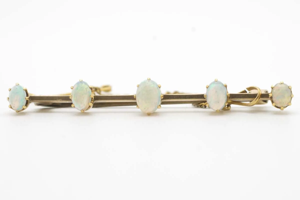 Antique gold bar brooch with five opal stones