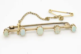 Antique gold bar brooch with five opal stones