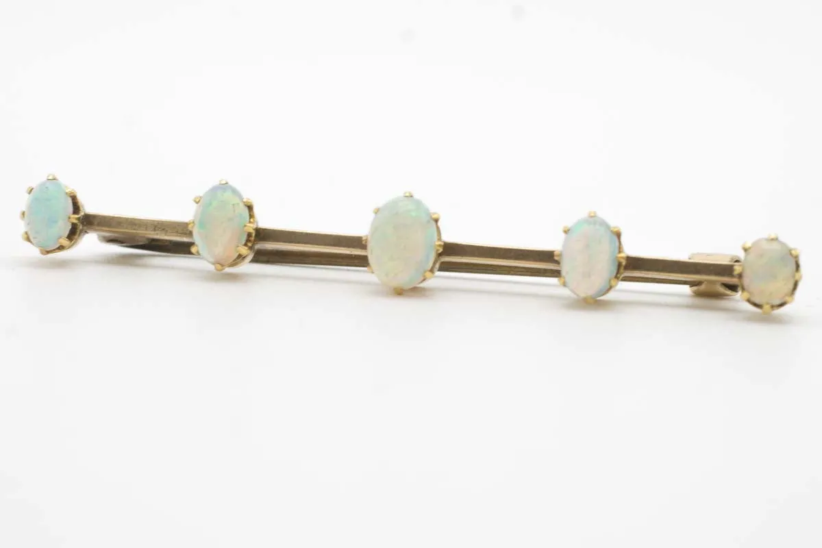 Antique gold bar brooch with five opal stones