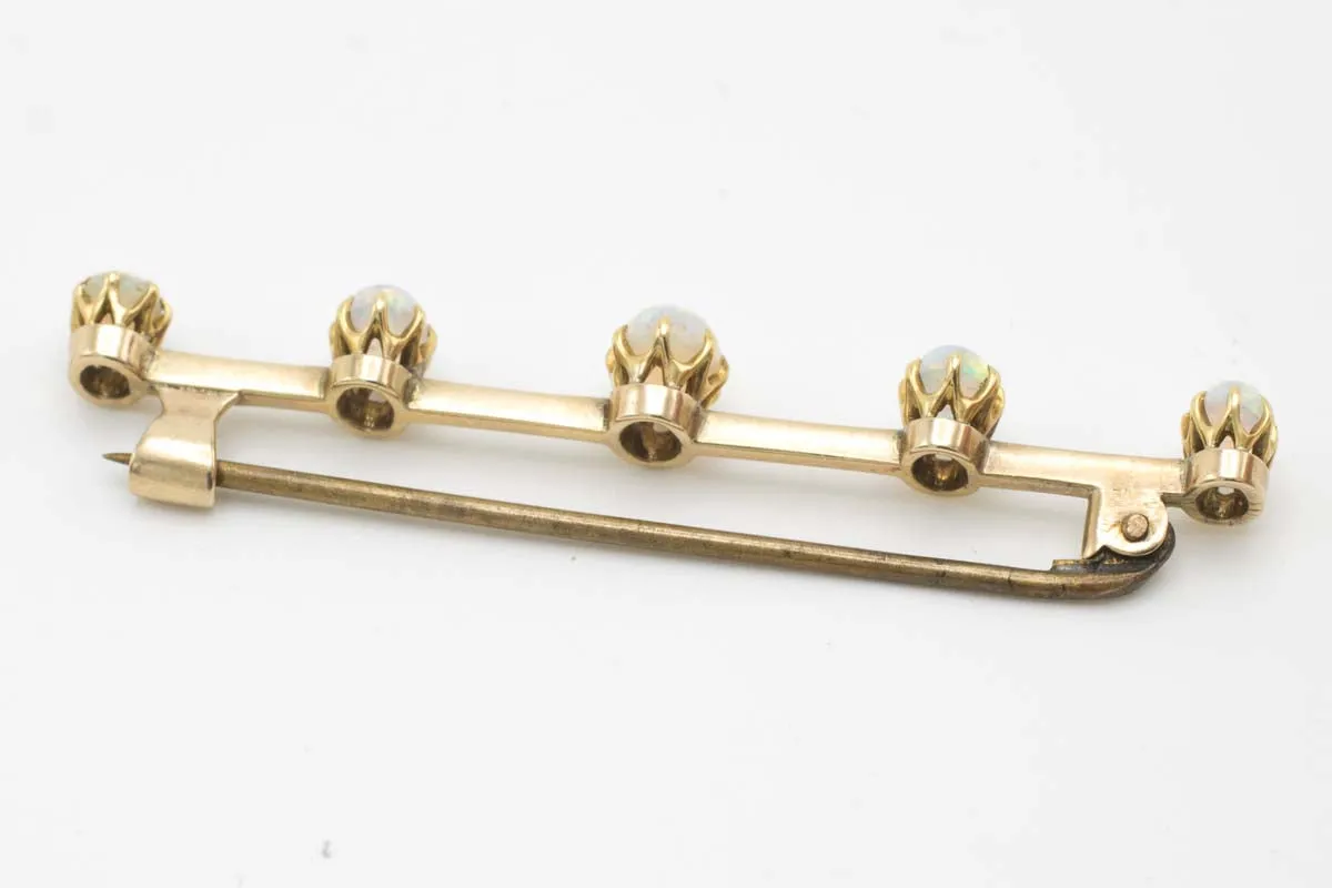 Antique gold bar brooch with five opal stones