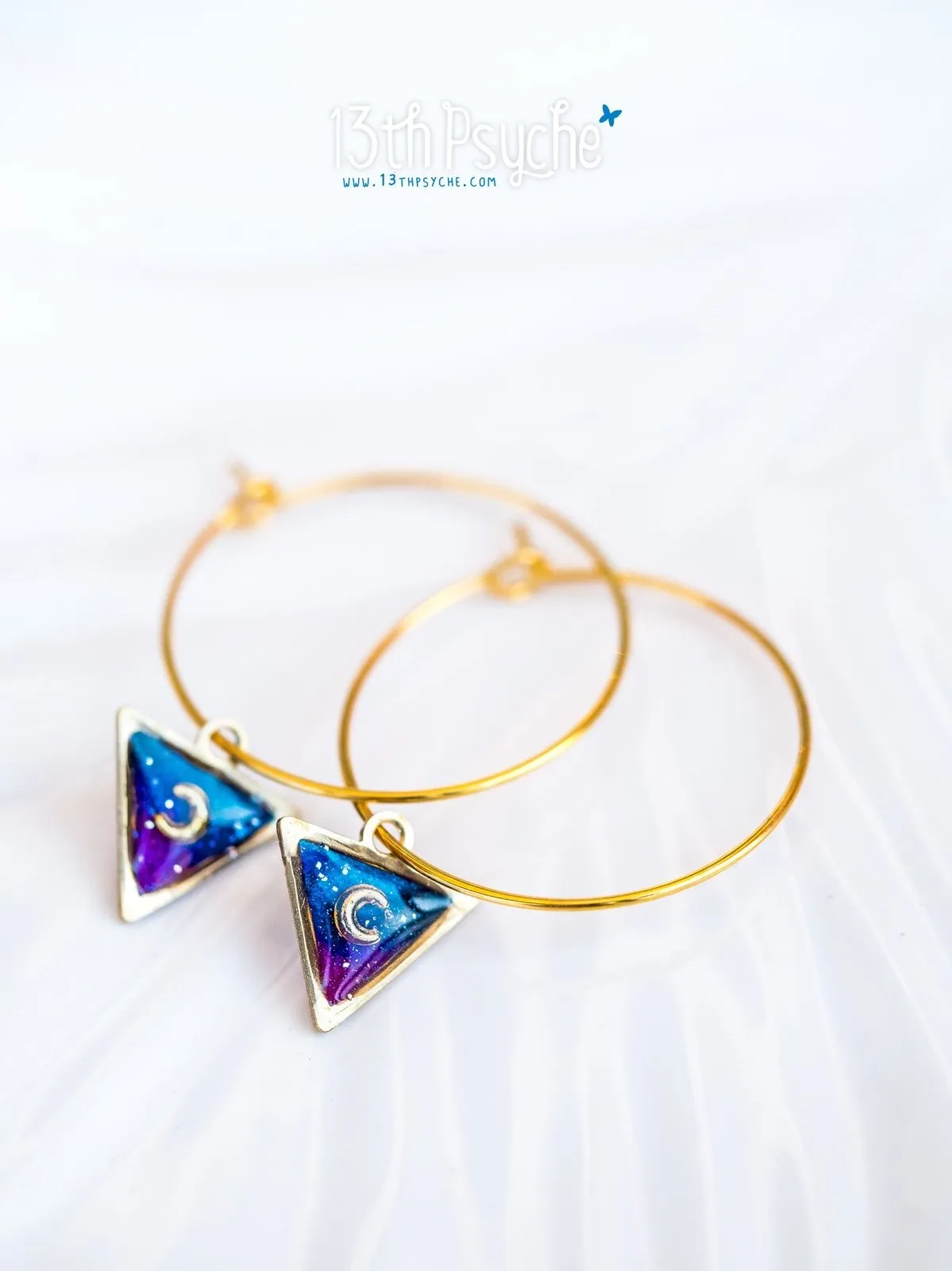 Hypoallergenic gold hoop earrings with triangle shape galaxy inspired charm