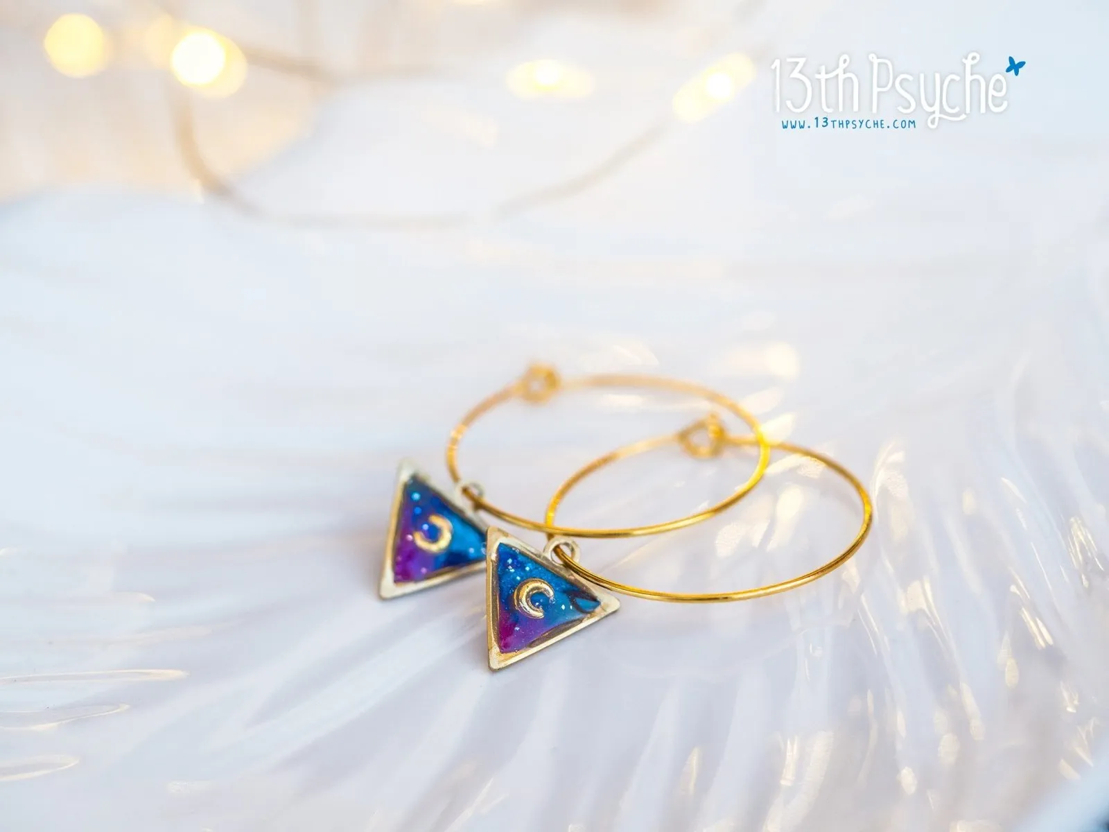 Hypoallergenic gold hoop earrings with triangle shape galaxy inspired charm